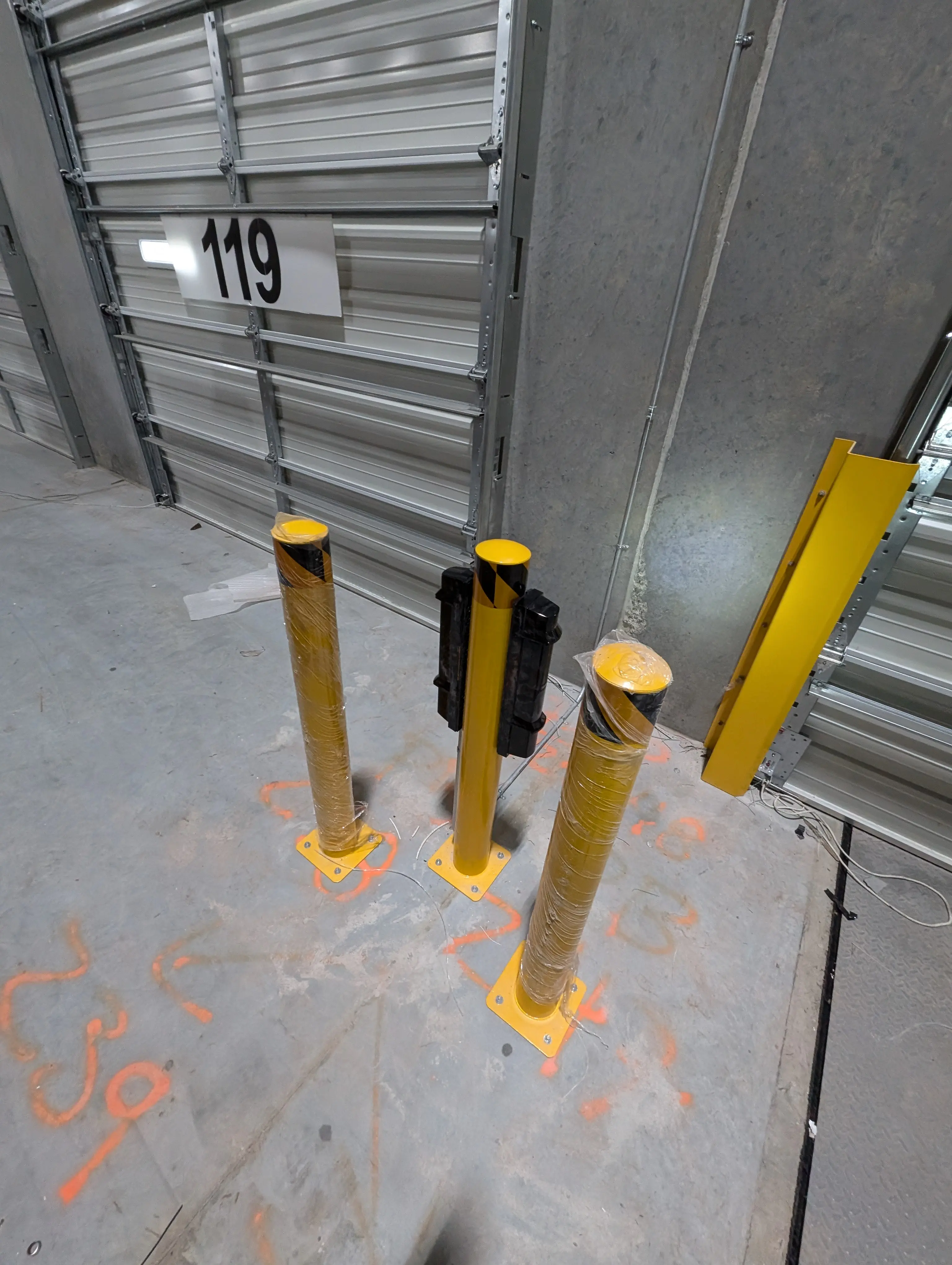 Two Optex SL-650QDP photobeams mounted on posts facing opposite directions at a loading dock