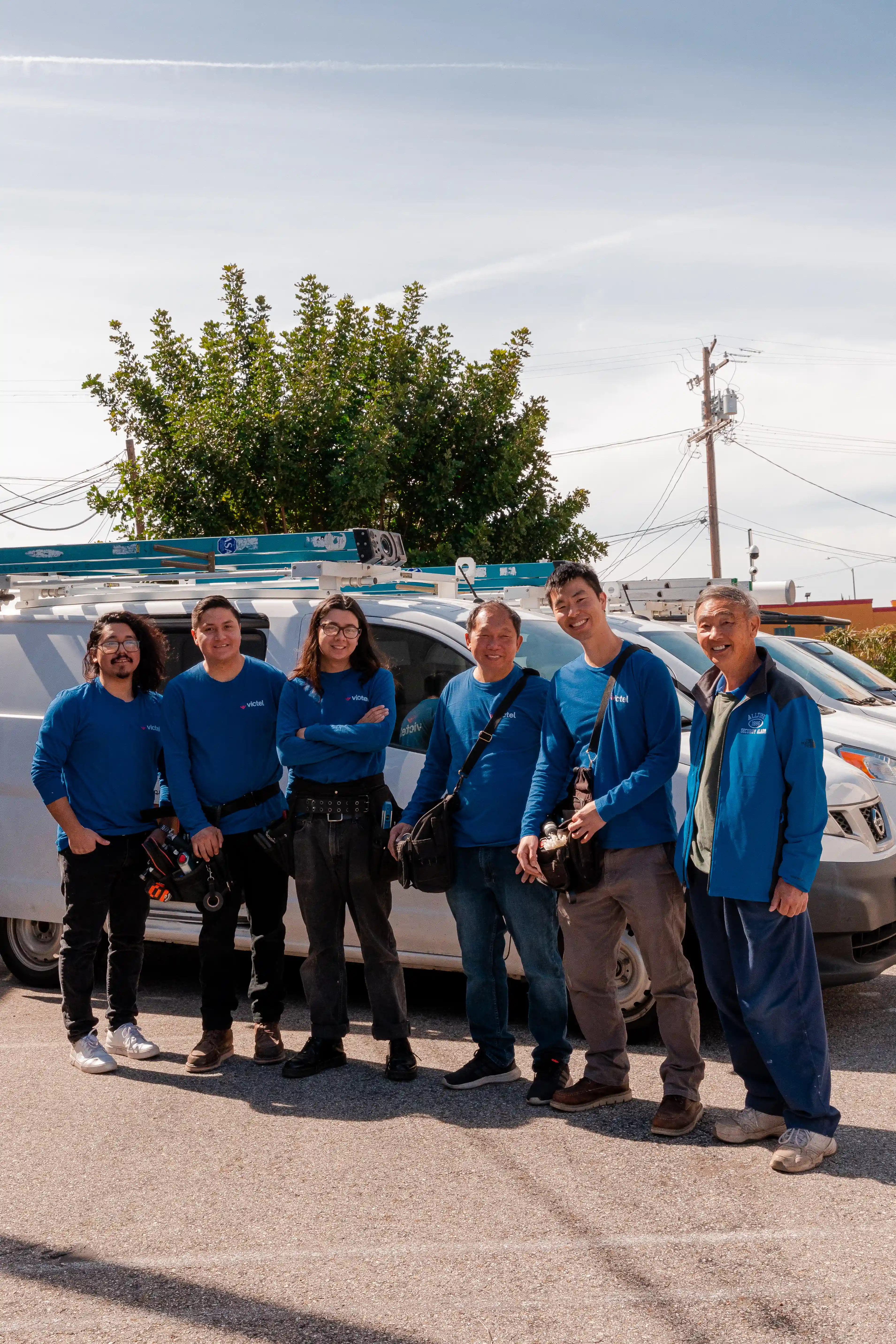 The AllTime Systems technician team standing together in front of a service van