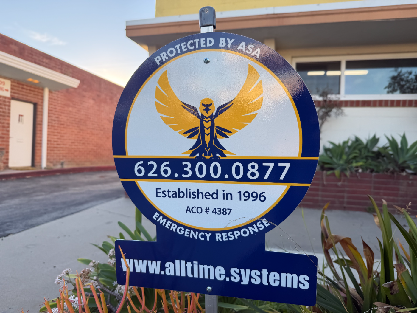AllTime Systems yard sign posted at a protected property, listing our emergency response line and established-1996 licensing